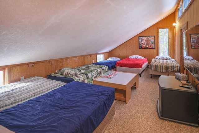 bedroom featuring a textured ceiling, vaulted ceiling, light colored carpet, and wood walls