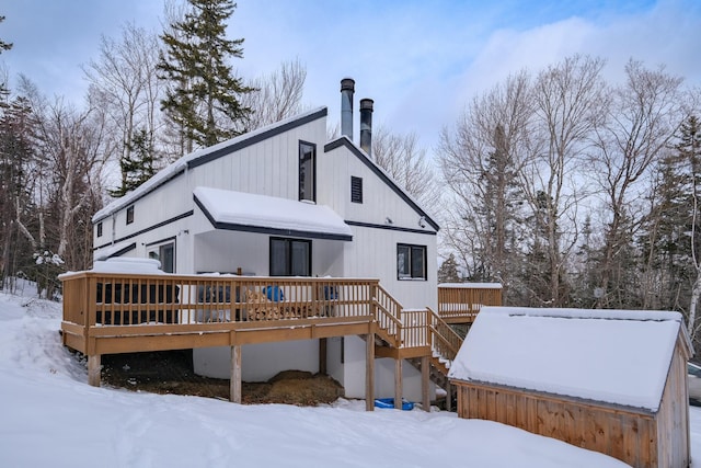 snow covered property featuring a wooden deck