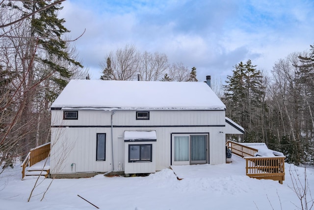 view of snow covered back of property