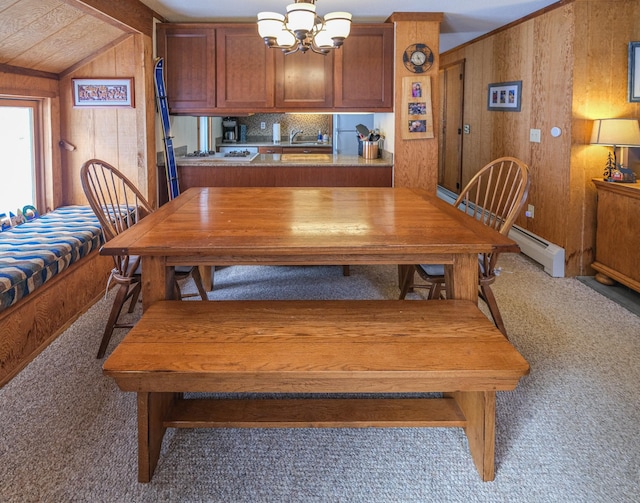 dining room with carpet, wooden walls, sink, lofted ceiling with beams, and a chandelier