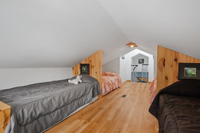 bedroom featuring lofted ceiling and light wood finished floors