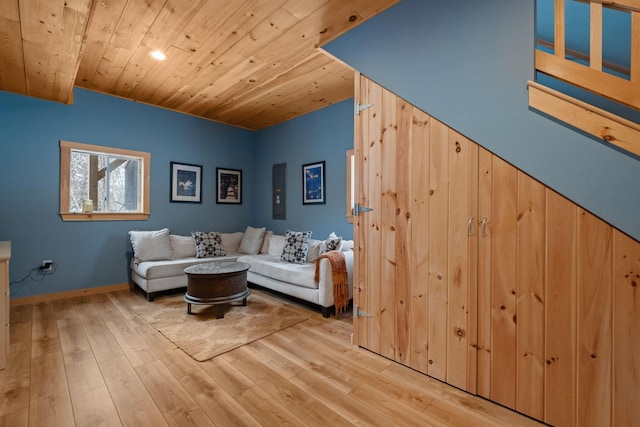 living area featuring wooden ceiling, baseboards, and wood finished floors