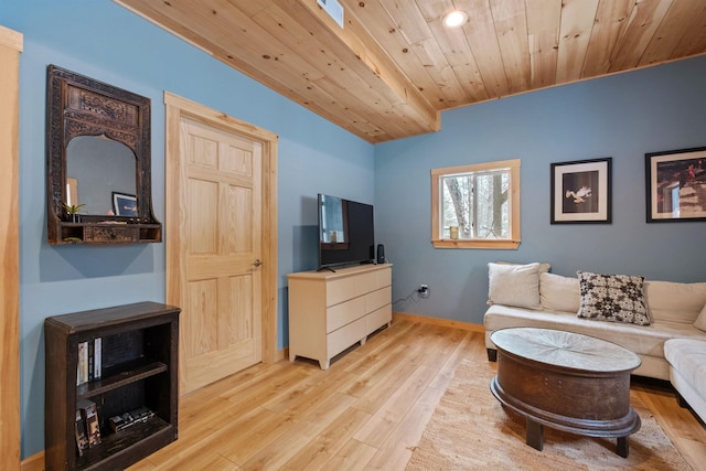 interior space featuring wooden ceiling, wood finished floors, and baseboards