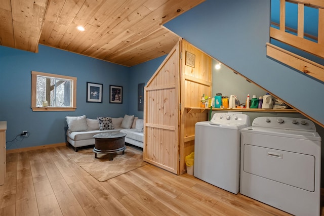 laundry room featuring laundry area, baseboards, wooden ceiling, light wood-style flooring, and separate washer and dryer