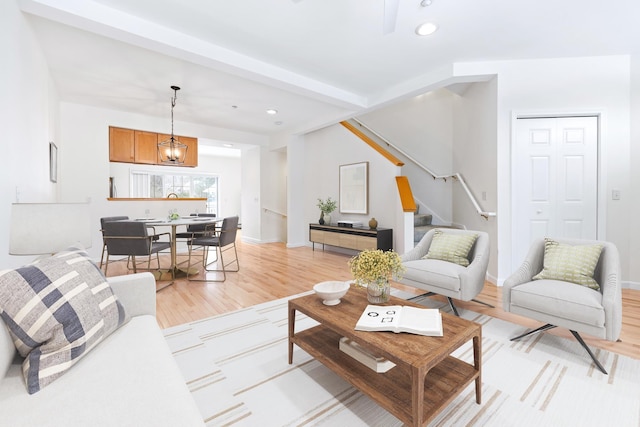 living room with a chandelier and light hardwood / wood-style flooring