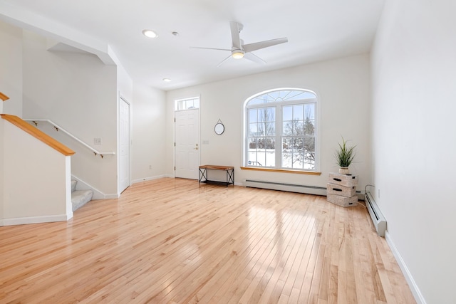 entrance foyer featuring light hardwood / wood-style floors, baseboard heating, and ceiling fan