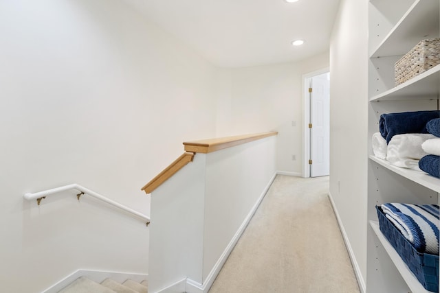 walk in closet with light colored carpet