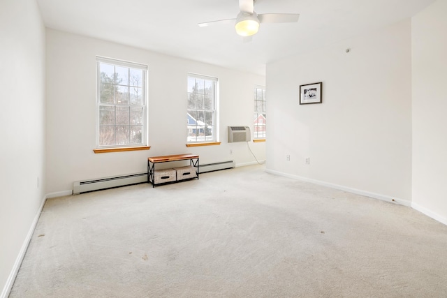 spare room with light carpet, ceiling fan, a wall unit AC, and a baseboard heating unit