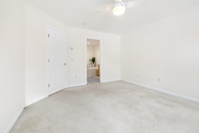 unfurnished room with ceiling fan and light carpet