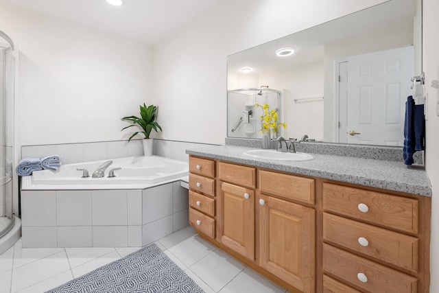 bathroom with tile patterned floors, separate shower and tub, and vanity