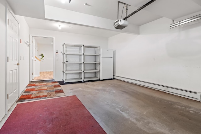 garage featuring a baseboard radiator, white fridge, and a garage door opener