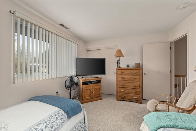 bedroom featuring light colored carpet