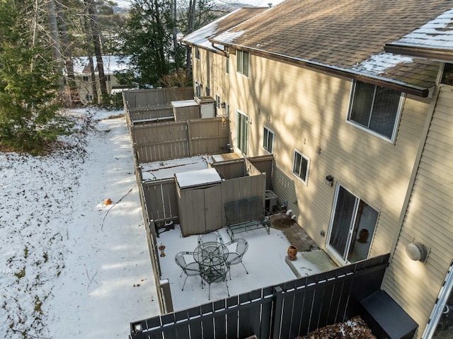 snow covered property featuring central air condition unit