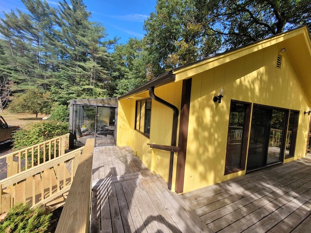 view of side of property with a deck and a sunroom