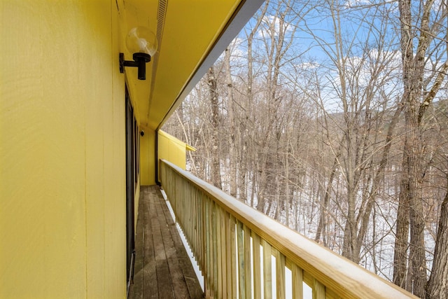 view of snow covered back of property