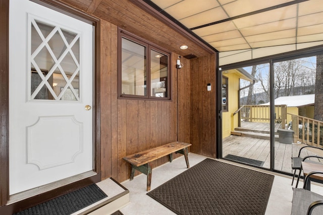 doorway featuring wooden walls