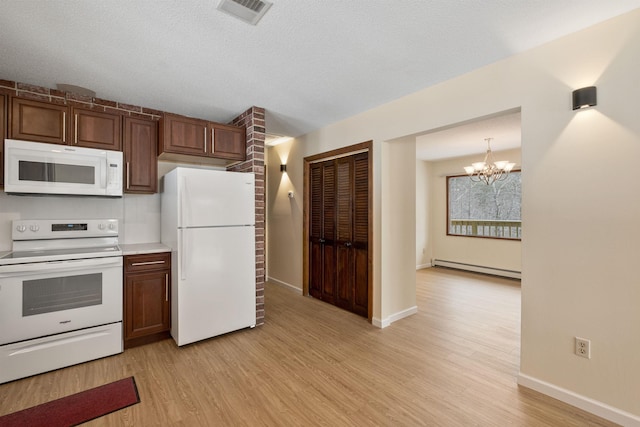 kitchen featuring a baseboard radiator, white appliances, hanging light fixtures, a chandelier, and light hardwood / wood-style flooring