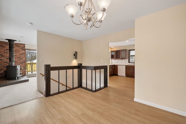 interior space with light wood-type flooring, a chandelier, and sink