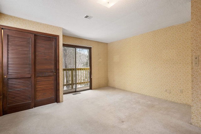 unfurnished bedroom with carpet and a closet