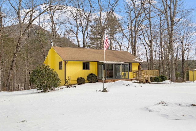 view of front of property with a deck and a sunroom