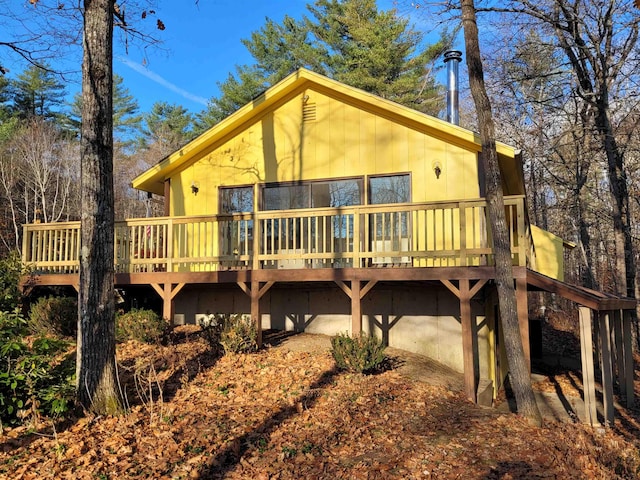 rear view of house featuring a deck