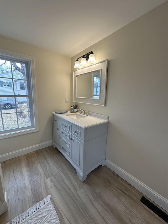 bathroom featuring wood-type flooring and vanity