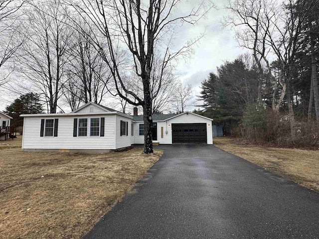 view of front facade featuring a garage and an outdoor structure