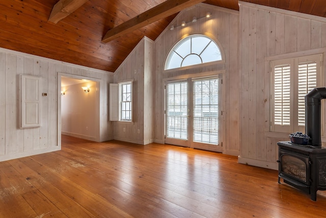 unfurnished living room with high vaulted ceiling, wooden ceiling, light hardwood / wood-style flooring, and beamed ceiling