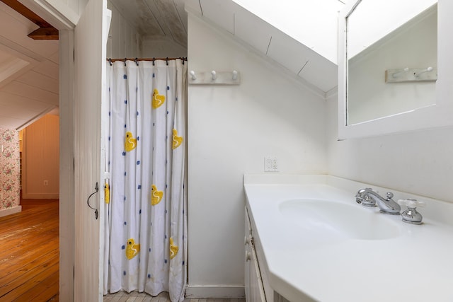 bathroom with vanity, vaulted ceiling, and a shower with shower curtain