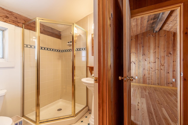 bathroom with vaulted ceiling with beams, walk in shower, and wooden walls