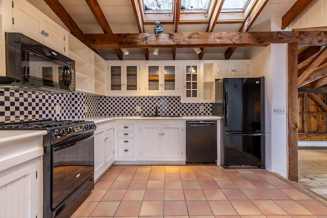 kitchen featuring backsplash, black appliances, sink, light tile patterned flooring, and white cabinets