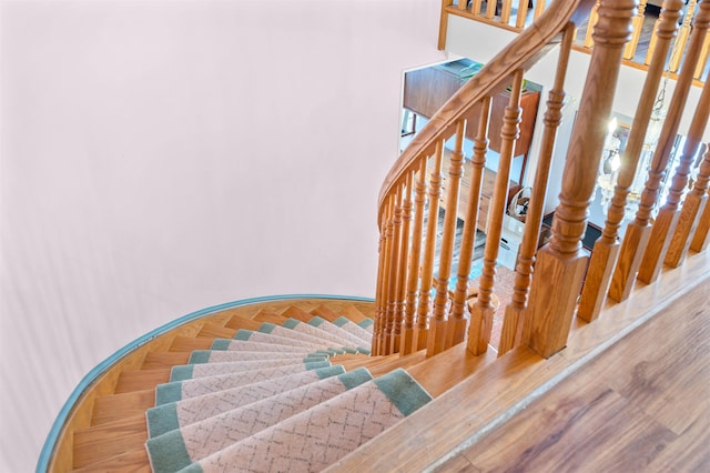 stairway with hardwood / wood-style flooring