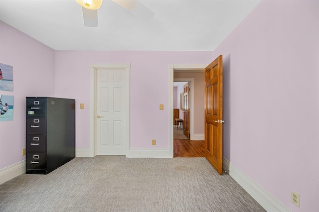 unfurnished bedroom featuring ceiling fan and carpet