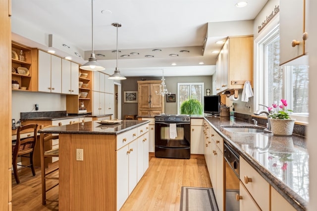 kitchen featuring white cabinetry, stainless steel dishwasher, a kitchen island, and black range oven