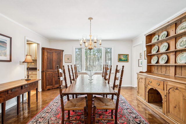 dining area featuring an inviting chandelier, crown molding, and light parquet floors