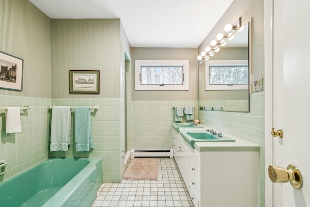 bathroom featuring vanity, tile patterned flooring, tile walls, a bath, and a baseboard radiator