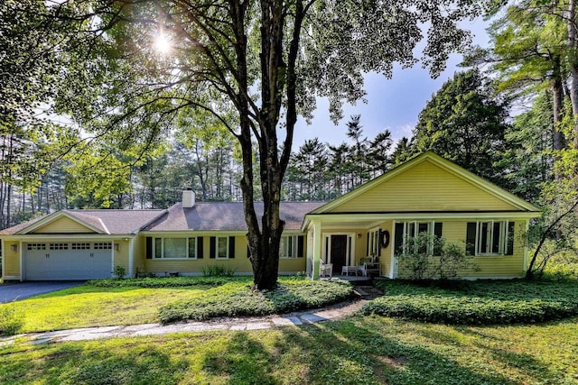 ranch-style home with a garage, a front lawn, and a porch