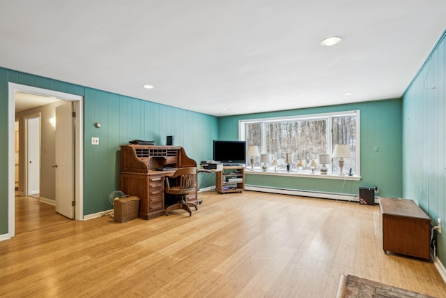 office area with light wood-type flooring and a baseboard radiator