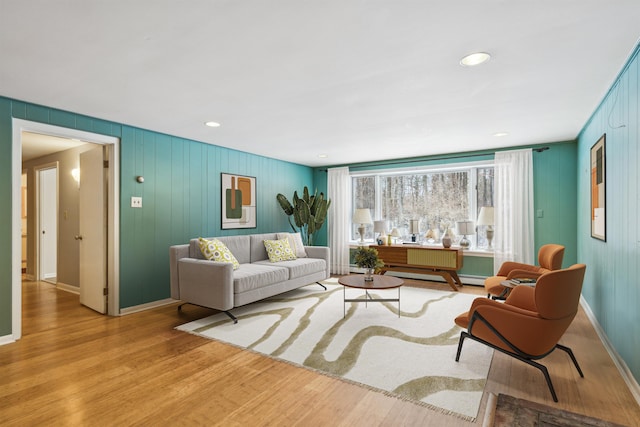 living room featuring baseboard heating and light wood-type flooring