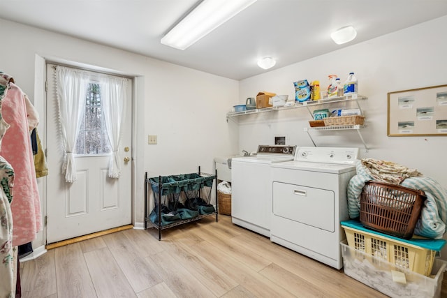 laundry area featuring light wood-type flooring and independent washer and dryer