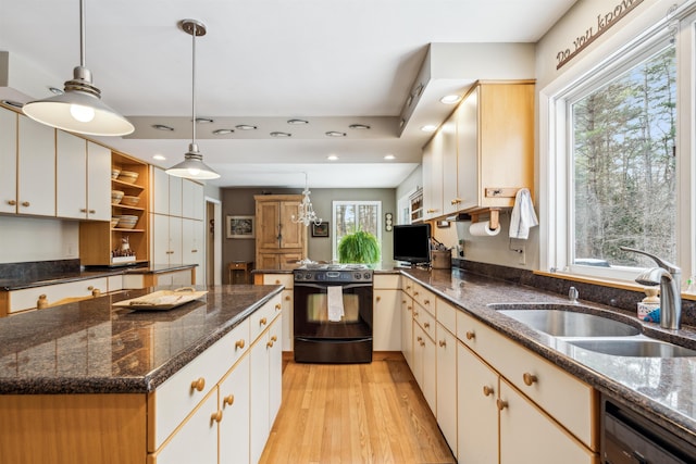 kitchen featuring pendant lighting, black appliances, a kitchen island, light hardwood / wood-style floors, and sink