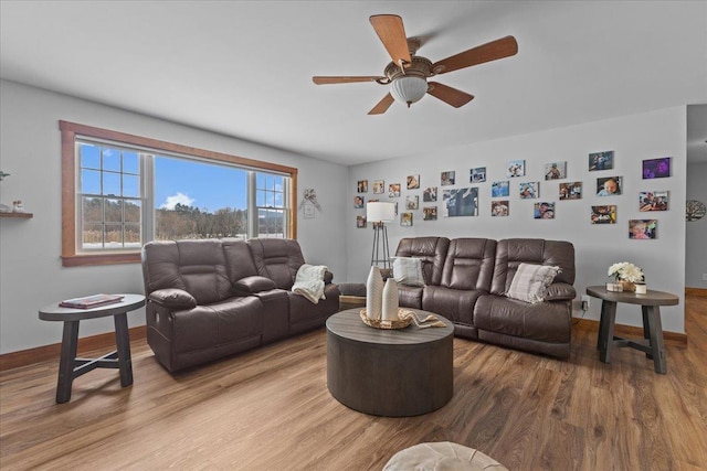 living room featuring ceiling fan and wood-type flooring