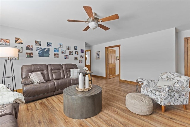 living room featuring hardwood / wood-style flooring and ceiling fan