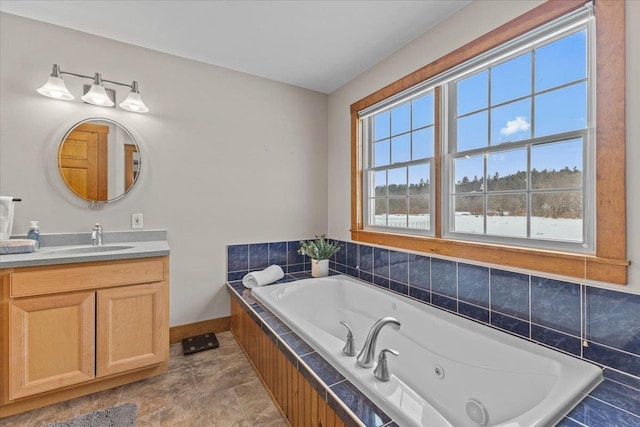 bathroom with tiled bath and vanity