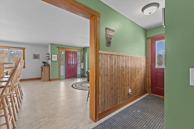 foyer with wood walls