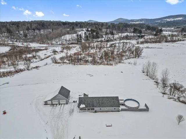 snowy aerial view with a mountain view