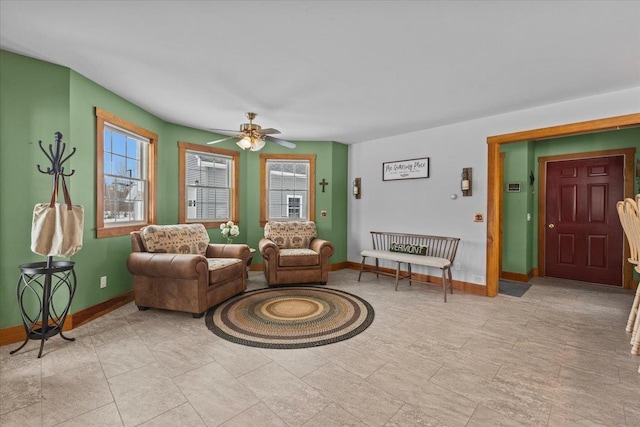 living room featuring ceiling fan and a wealth of natural light