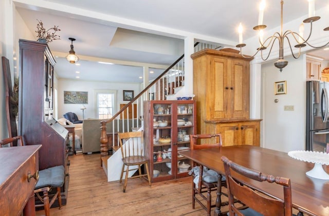 dining room featuring light hardwood / wood-style floors and a notable chandelier