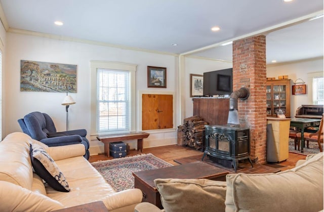 living room with crown molding, a wood stove, and wood-type flooring