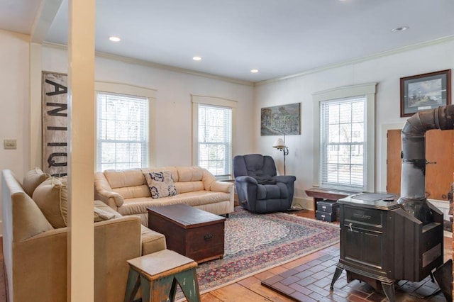 living room with a wood stove and ornamental molding